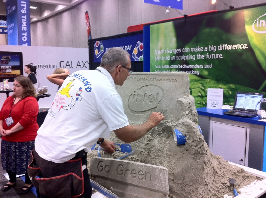 Archisand sculpts the Intel logo at BlogHer '11